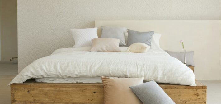white bed pillow on brown wooden bed frame